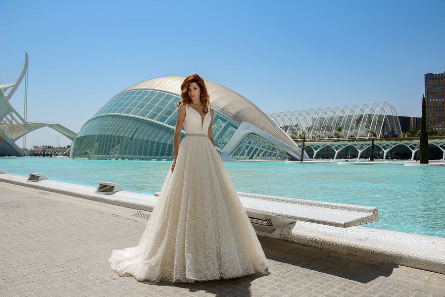 This elegant wedding gown is exclusive to Bride and Reflections and is available is plus sizes.